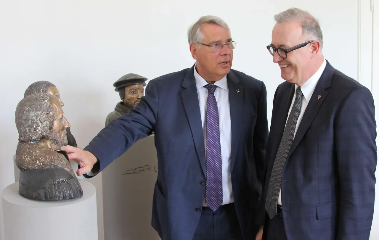 Der pfälzische Kirchenpräsident Christian Schad (l.) führt seinen Gast, den württembergischen Landesbischof Dr. h. c. Frank Otfried July, durch eine Austellung kirchlicher Kulturgüter.